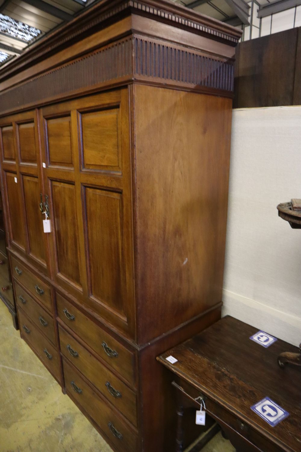A large late Victorian walnut wardrobe, with fielded panelled doors over six small drawers, width 180cm depth 60cm height 210cm